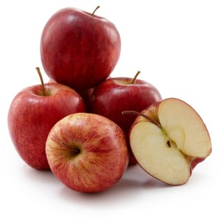 Apple 'Royal Gala' fruit: a pile of red-streaked apples with short stalks beside a halved apple showing pale cream flesh, on white.
