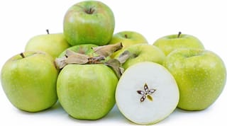 Apple 'Royal Gala/Granny Smith' fruit: a pile of green, lightly speckled apples with a few dried leaves, one halved to show its seeds.