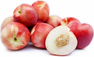 Nectarine 'Queen Giant' fruit, a pile of whole red and cream nectarines beside a halved one showing white flesh and stone.