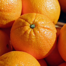 Ripe Citrus orange 'Newhall' with vibrant orange peel, showcasing its fresh, juicy texture and characteristic shape