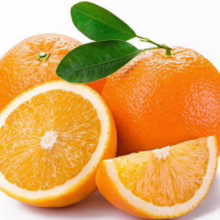 Fresh Citrus orange 'Washington Navel', whole and sliced, with vibrant orange peel and green leaves.