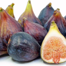 Ripe figs: A cluster of dark purple and reddish-brown figs, one cut open to reveal its seedy, fleshy interior. The figs have a teardrop shape and small stems.
