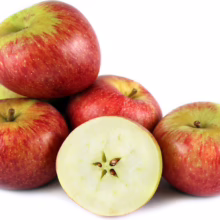 Pile of ‘Golden Delicious/Braeburn’ apples, showing red and green skin, with one apple cut to reveal star-shaped core
