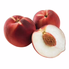 Three ripe white peaches, two whole with deep red skin and one cut in half showing the white flesh and pit. Fresh summer fruit.