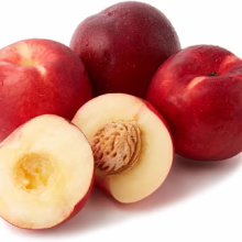 Fresh, ripe nectarines, some whole with vibrant red skin and water droplets, and one sliced open revealing the white flesh and pit.