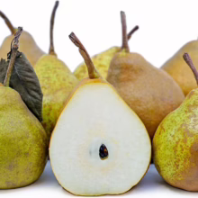 Group of ripe pears, some whole with stems, one cut in half showing seeds, against a white background.